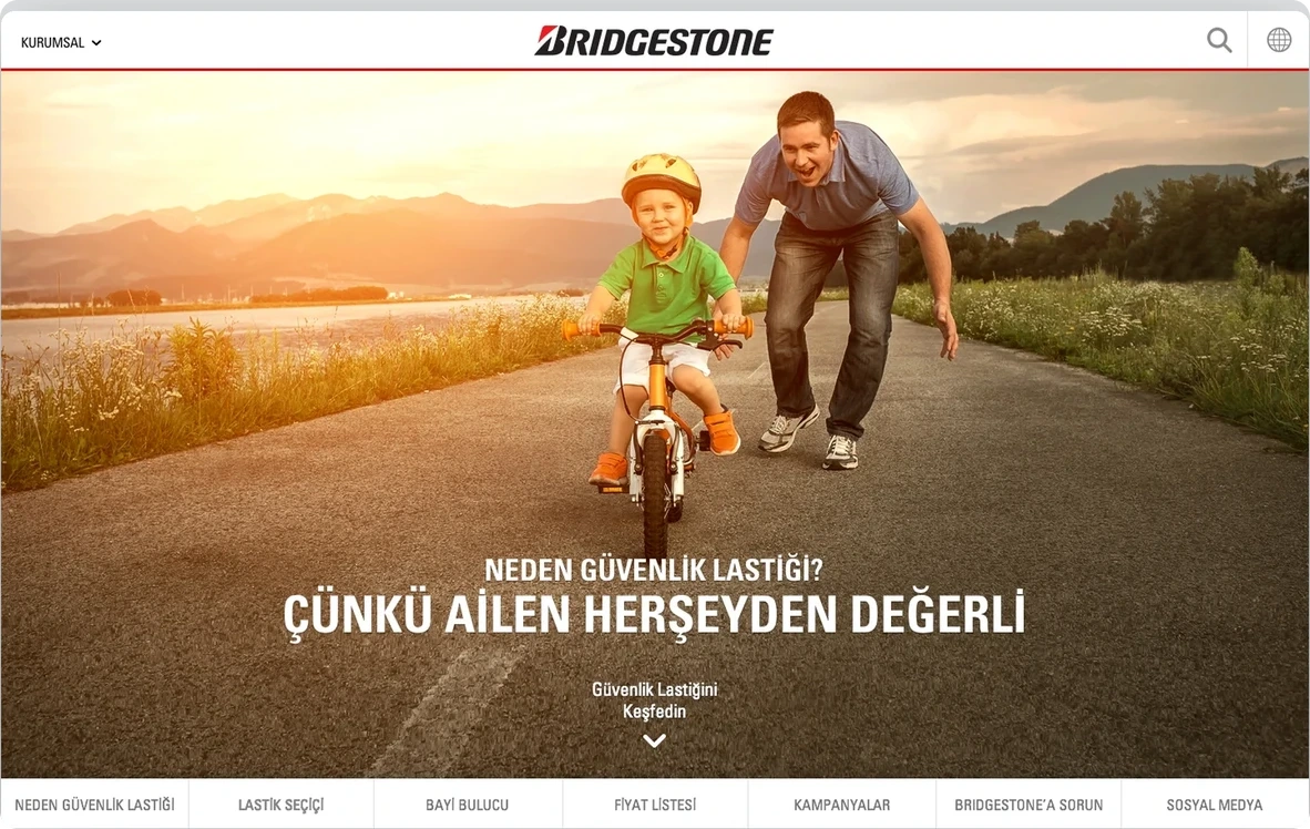 Bridgestone homepage with a photograph of a child cycling with his father
