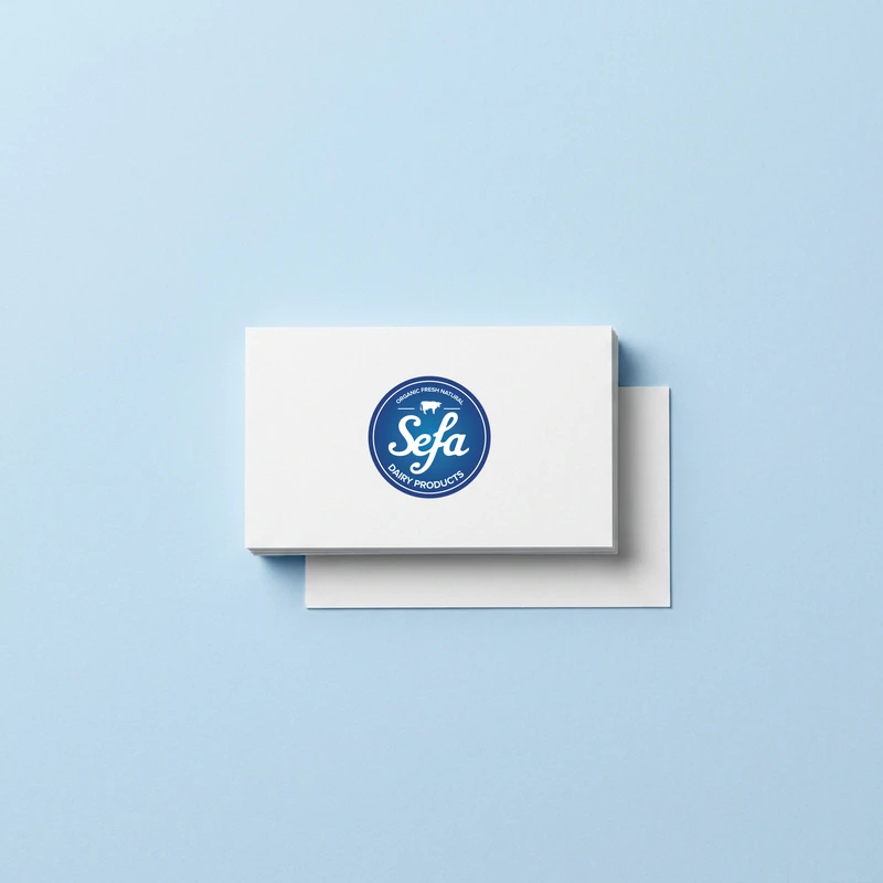 White Sefa Dairy business card on a light blue background.
